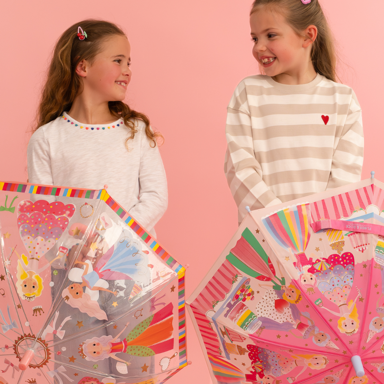 Colour changing umbrella - lifestyle photo of two girls holding princess design colour changing umbrellas 
